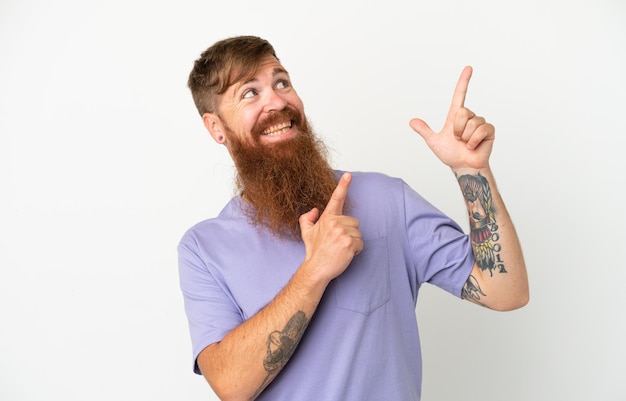 Young reddish caucasian man isolated on white background pointing with the index finger a great idea