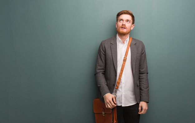 Young redhead businessman tired and bored