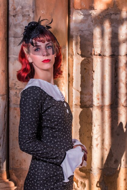 Young redhead girl on a retro vintage dress