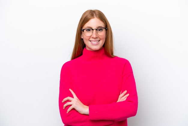 Young redhead woman isolated on white background keeping the arms crossed in frontal position