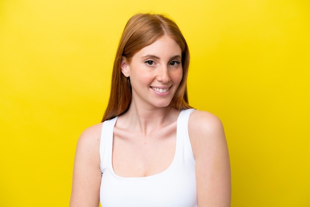 Young redhead woman isolated on yellow background Portrait