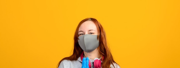 Young redhead woman wearing a medical mask