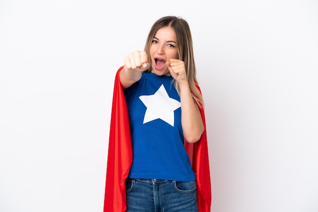 Young Romanian woman isolated on white background in superhero costume and fighting