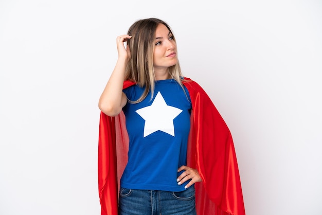 Young Romanian woman isolated on white background in superhero costume and having doubts