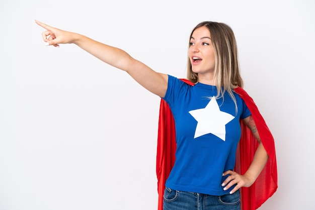 Young Romanian woman isolated on white background in superhero costume with proud gesture