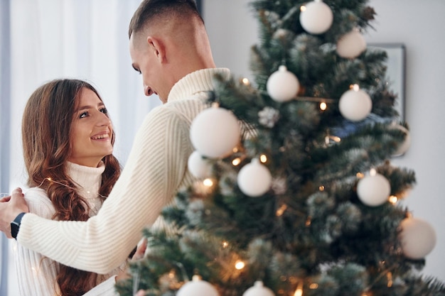 Young romantic couple celebrates New year together indoors