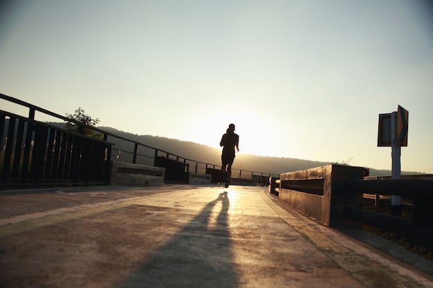 Young runners run on the runway during the evening hours.
Healthy jogging concepts (silhouette)