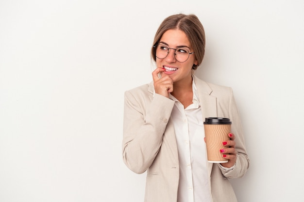 Young Russian business woman holding banknotes isolated on white background relaxed thinking about something looking at a copy space.