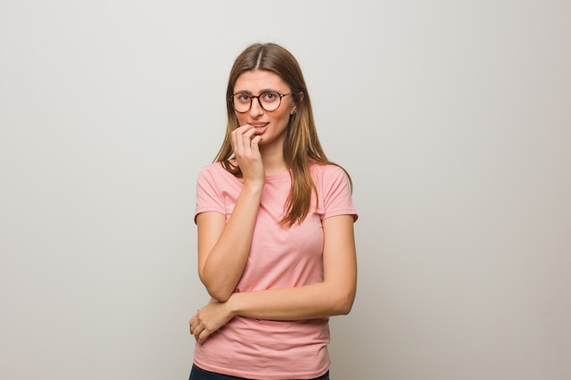 Young russian natural girl biting nails, nervous and very anxious