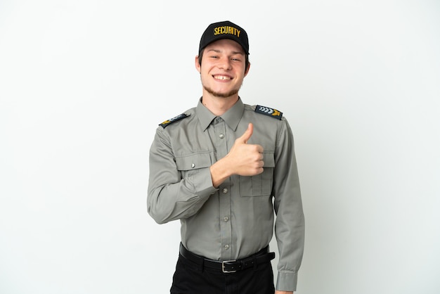 Young Russian security man isolated on white surface giving a thumbs up gesture