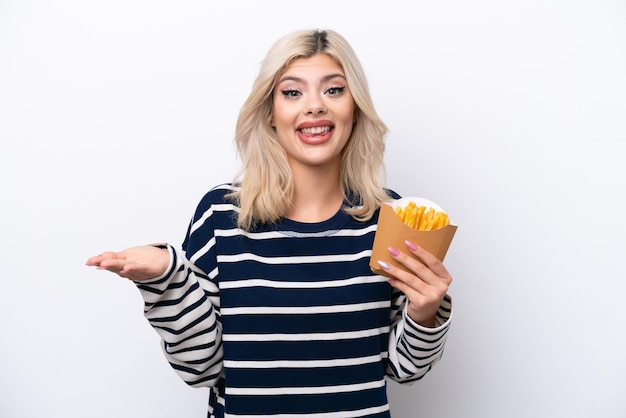 Young Russian woman catching french fries isolated on white background with shocked facial expression