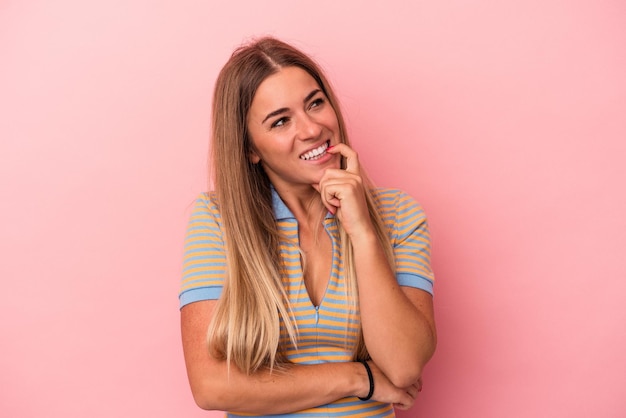 Young Russian woman isolated on pink background raising fist after a victory, winner concept.