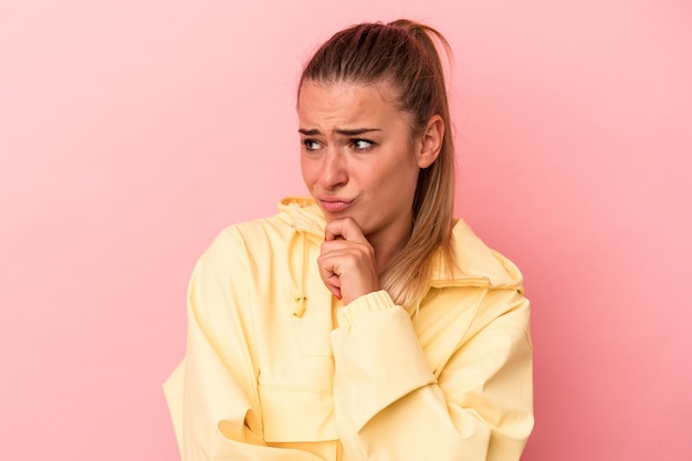 Young Russian woman isolated on pink background suffers pain in throat due a virus or infection.