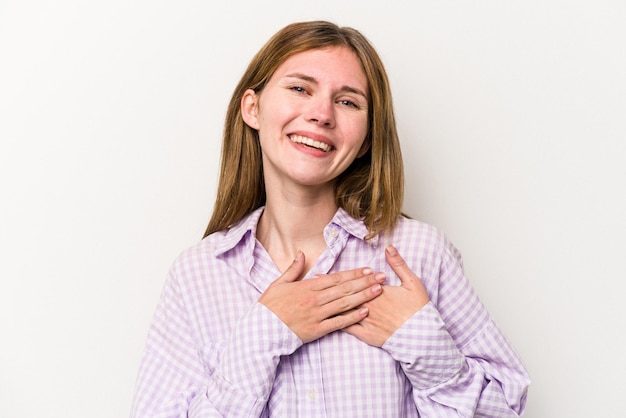 Young russian woman isolated on white background has friendly expression pressing palm to chest Love concept