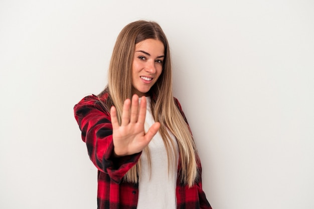 Young Russian woman isolated on white background indicates with both fore fingers up showing a blank space.