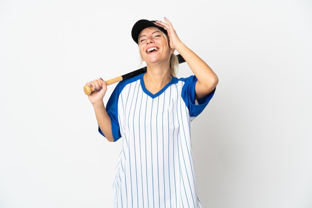 Young Russian woman playing baseball isolated on white background smiling a lot