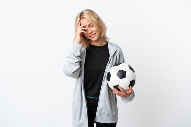 Young Russian woman playing football isolated on white background laughing