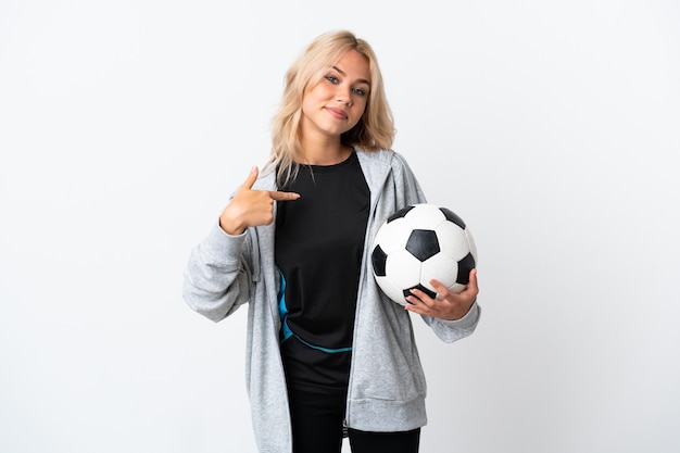 Young Russian woman playing football isolated on white background proud and self-satisfied