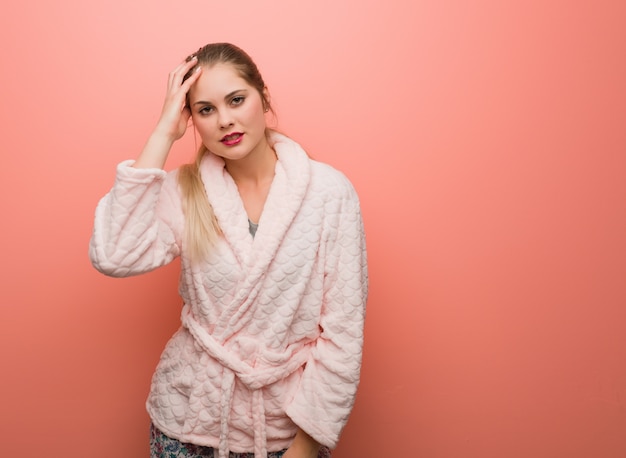 Young russian woman wearing pajama tired and very sleepy