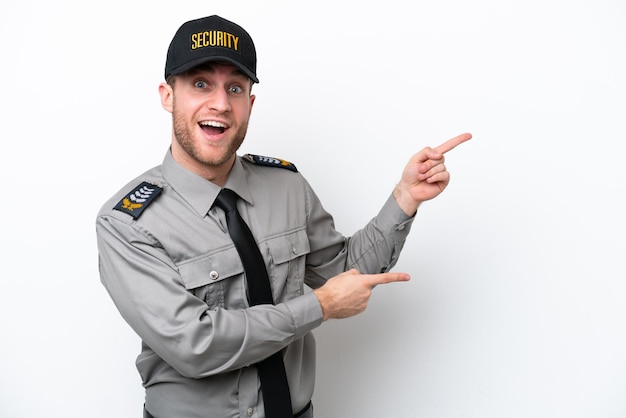 Young safeguard caucasian man isolated on white background surprised and pointing side