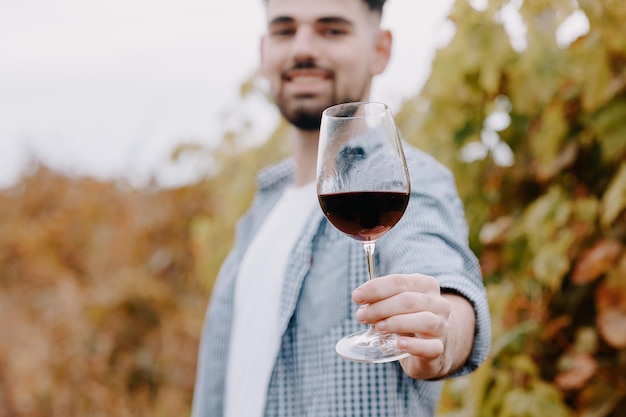 Young satisfied person holding a glass of wine Wine making and tasting concept