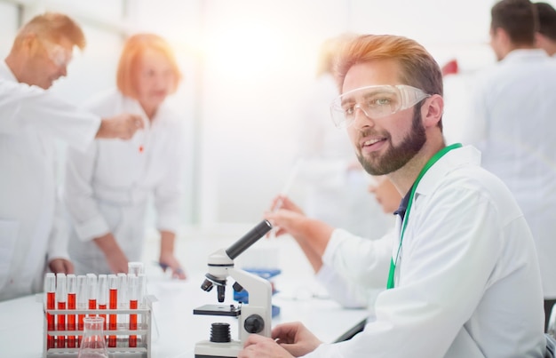 Young scientist is working with a microscope in the laboratory