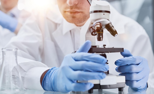 Young scientist looking through a microscope in a laboratory young scientist doing some research