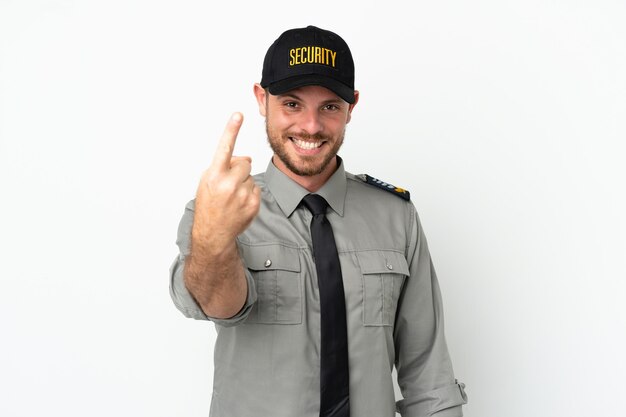 Young security Brazilian man isolated on white background doing coming gesture