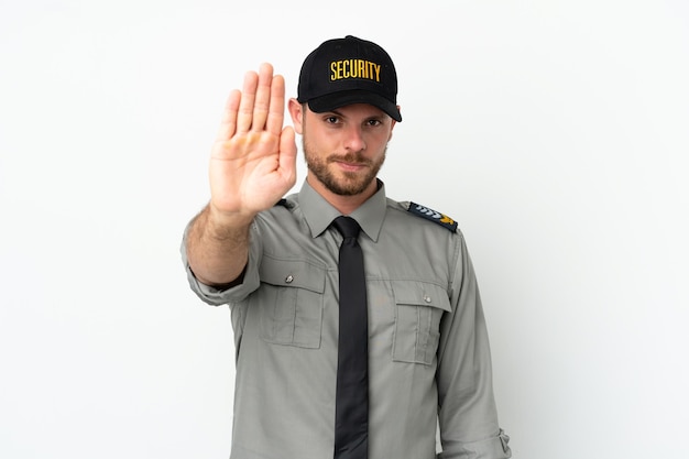 Young security Brazilian man isolated on white background making stop gesture