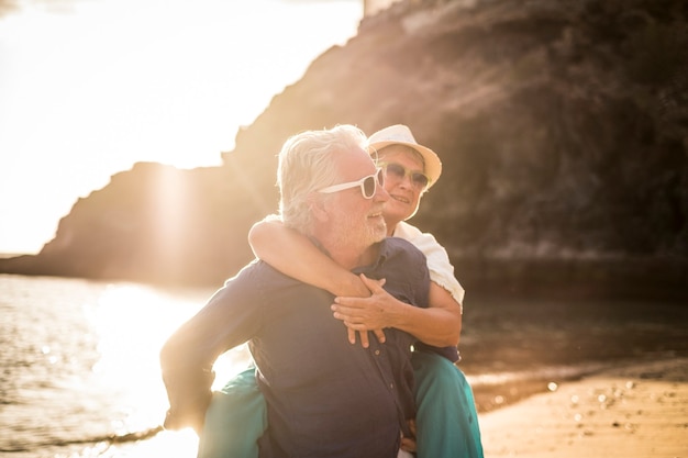 Young senior couple in love enjoy summer time at the beach