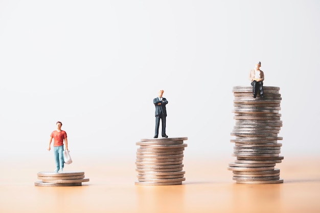 Young Senior and old men miniature figure standing in different high of coins stacking for money saving and investment since start working to retirement concept