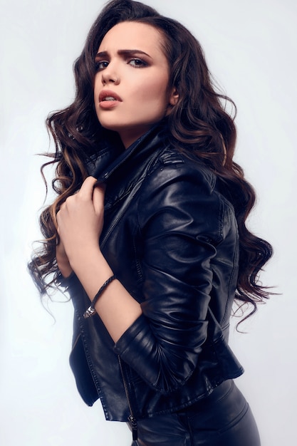 Young sexy girl with long hair in leather jacket