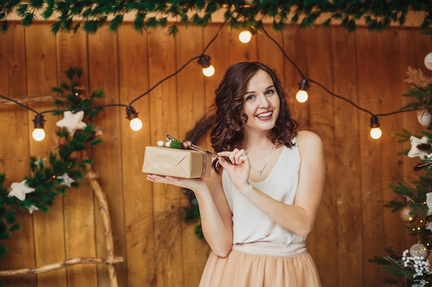 Young sexy woman brunette with gift. New year of christmas concept