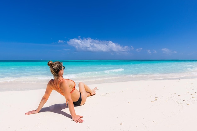 Young sexy woman relax on the beach. Perfect tropical island, beach shore turquoise ocean lagoon bay