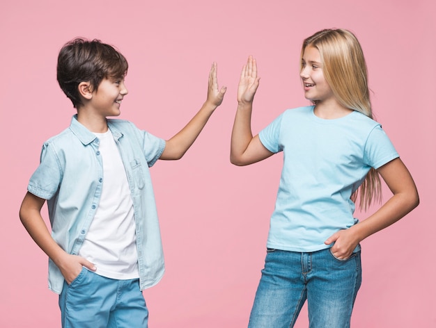 Young siblings giving high five