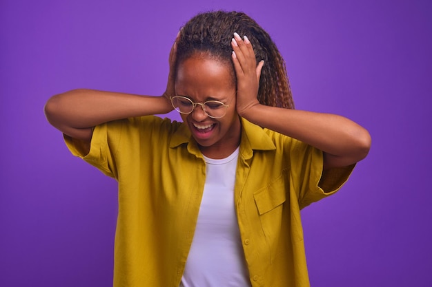 Young sick african american woman clutching head after having panic attack