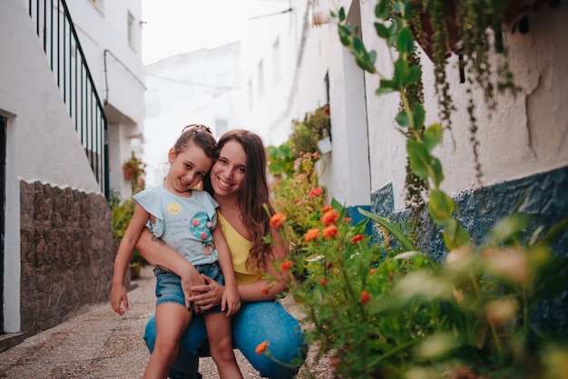 Young sisters of four and 20s happy around plants