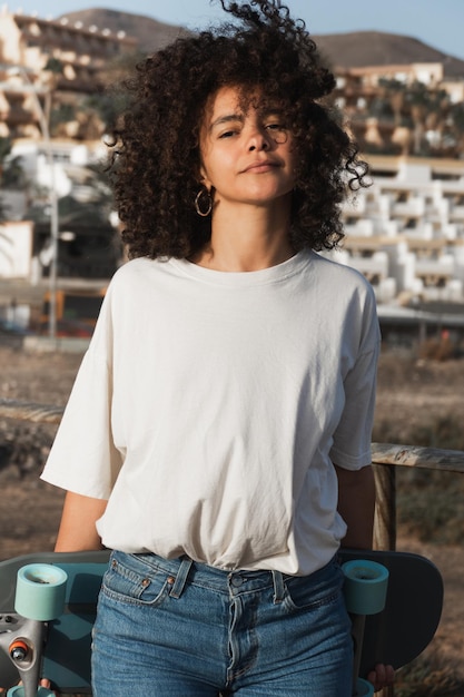 Young skater female with afro hair portrait outdoor