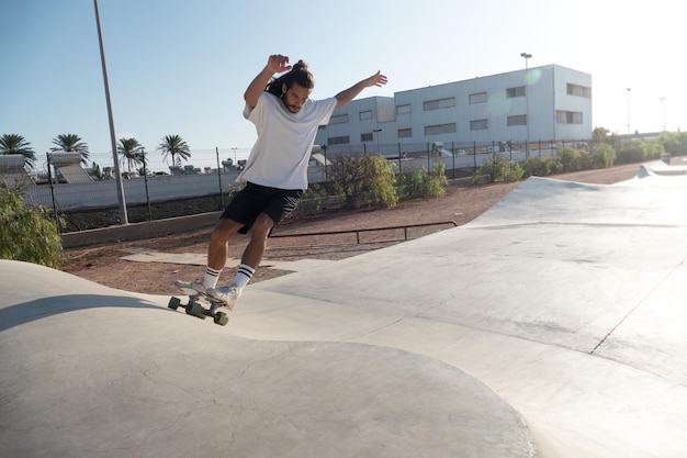 Young skater riding on the skate park ramps