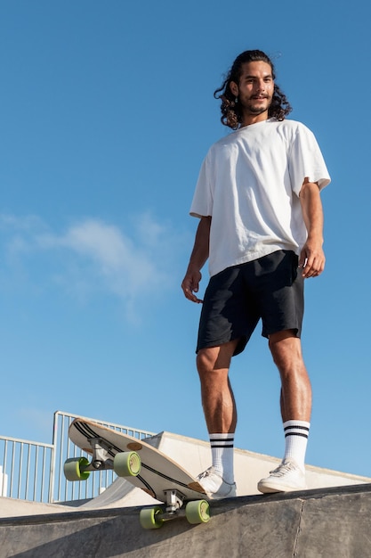 Young skater standing at the top of the skate ramp