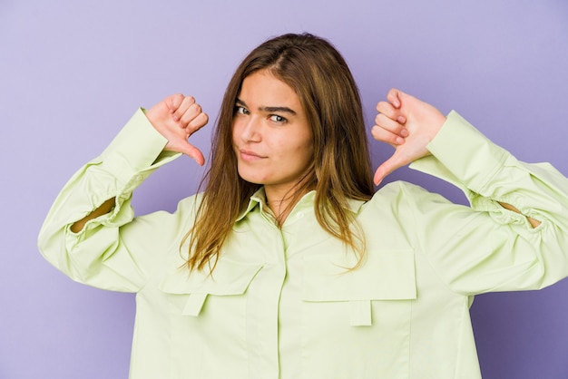 Photo young skinny caucasian girl teenager on purple background feels proud and self confident, example to follow.