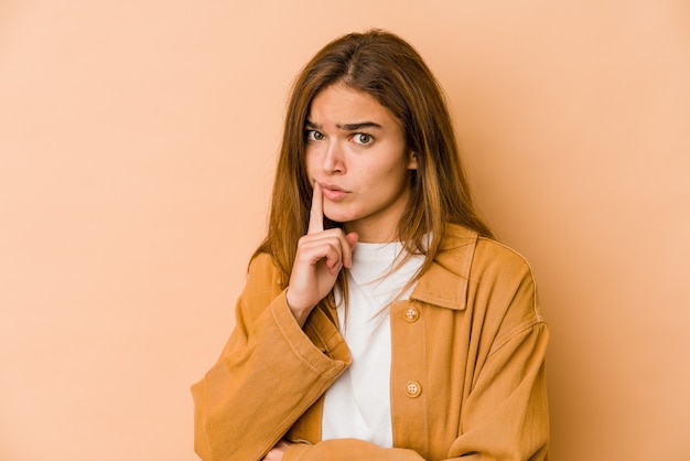 Young skinny caucasian teenager girl looking sideways with doubtful and skeptical expression.