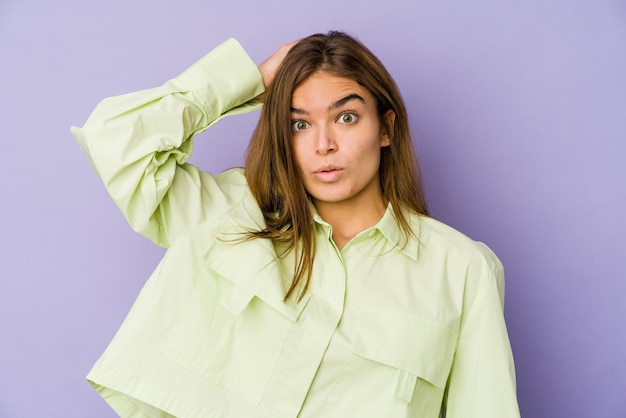 Young skinny caucasian woman on purple being shocked, she has remembered important meeting.