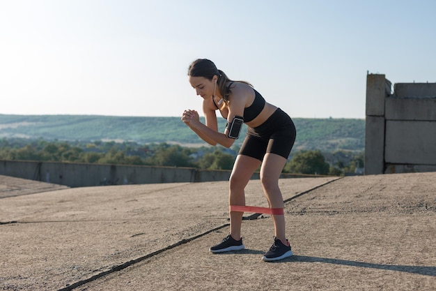 A young slim athletic girl in sportswear performs a set of exercises Fitness and healthy lifestyle