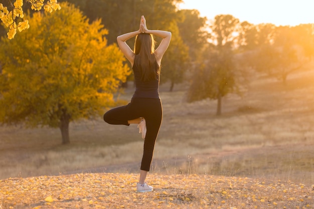 A young slim athletic girl in sportswear performs a set of exercises Fitness and healthy lifestyle