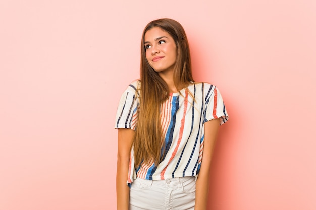 Young slim woman dreaming of achieving goals and purposes