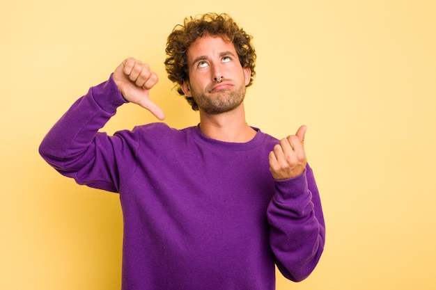 Photo young smart caucasian man on yellow background showing that she has no money