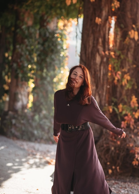 Young smiling attractive woman in morning sunrise dancing in dress healthy lifestyle having fun