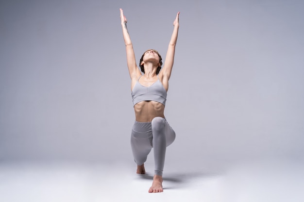 Young smiling attractive woman practicing yoga