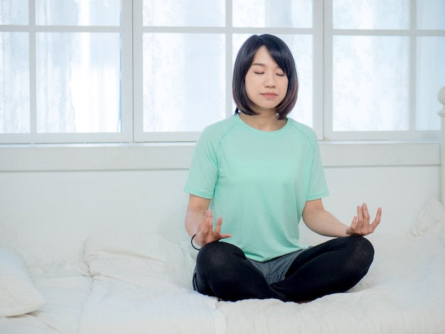 Young smiling attractive yogi woman practicing yoga